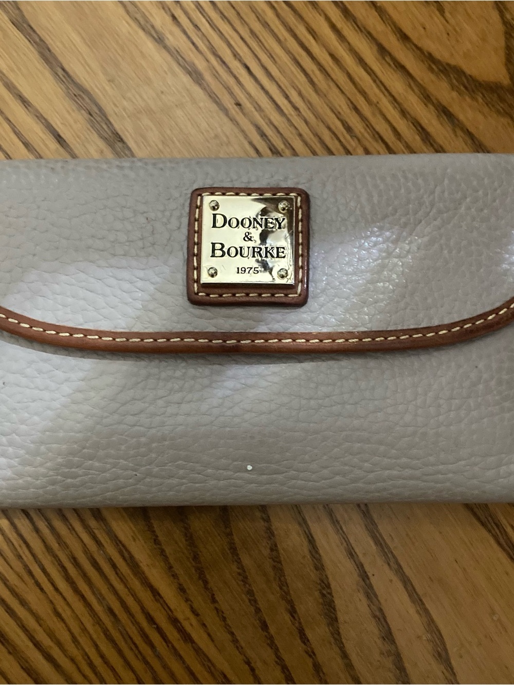 Dooney & Bourke Taupe Leather Wallet with Brown Trim and Gold Plaque